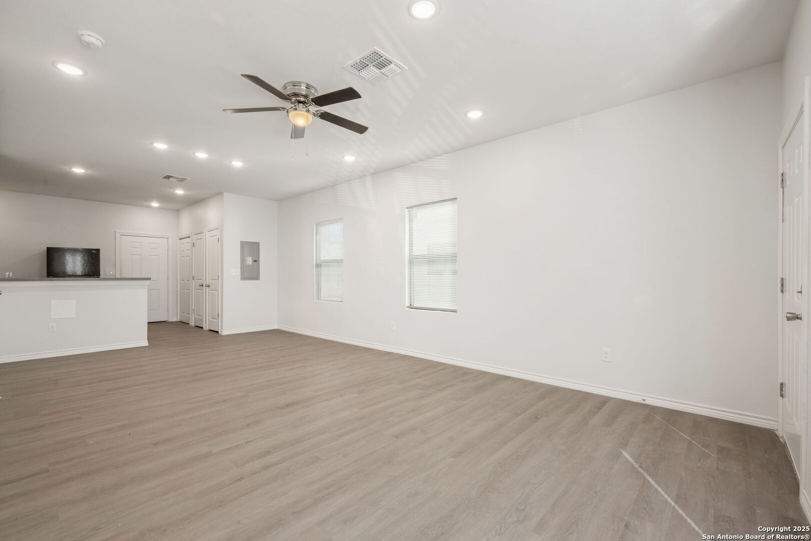 8719 Wurzbach Road, Unit 202 San Antonio, TX 78240 - Photo 3 of 18 a view of an empty room with a ceiling fan