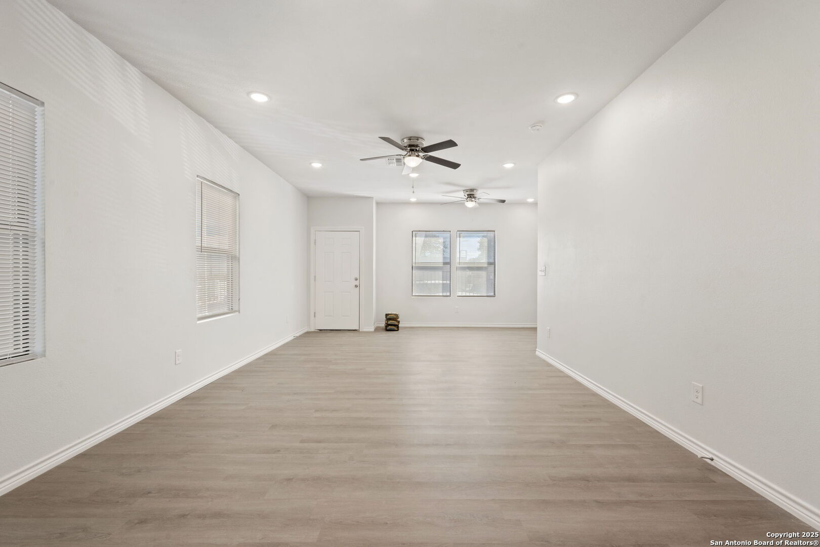 8719 Wurzbach Road, Unit 202 San Antonio, TX 78240 - Photo 4 of 18 wooden floor in an empty room with a window