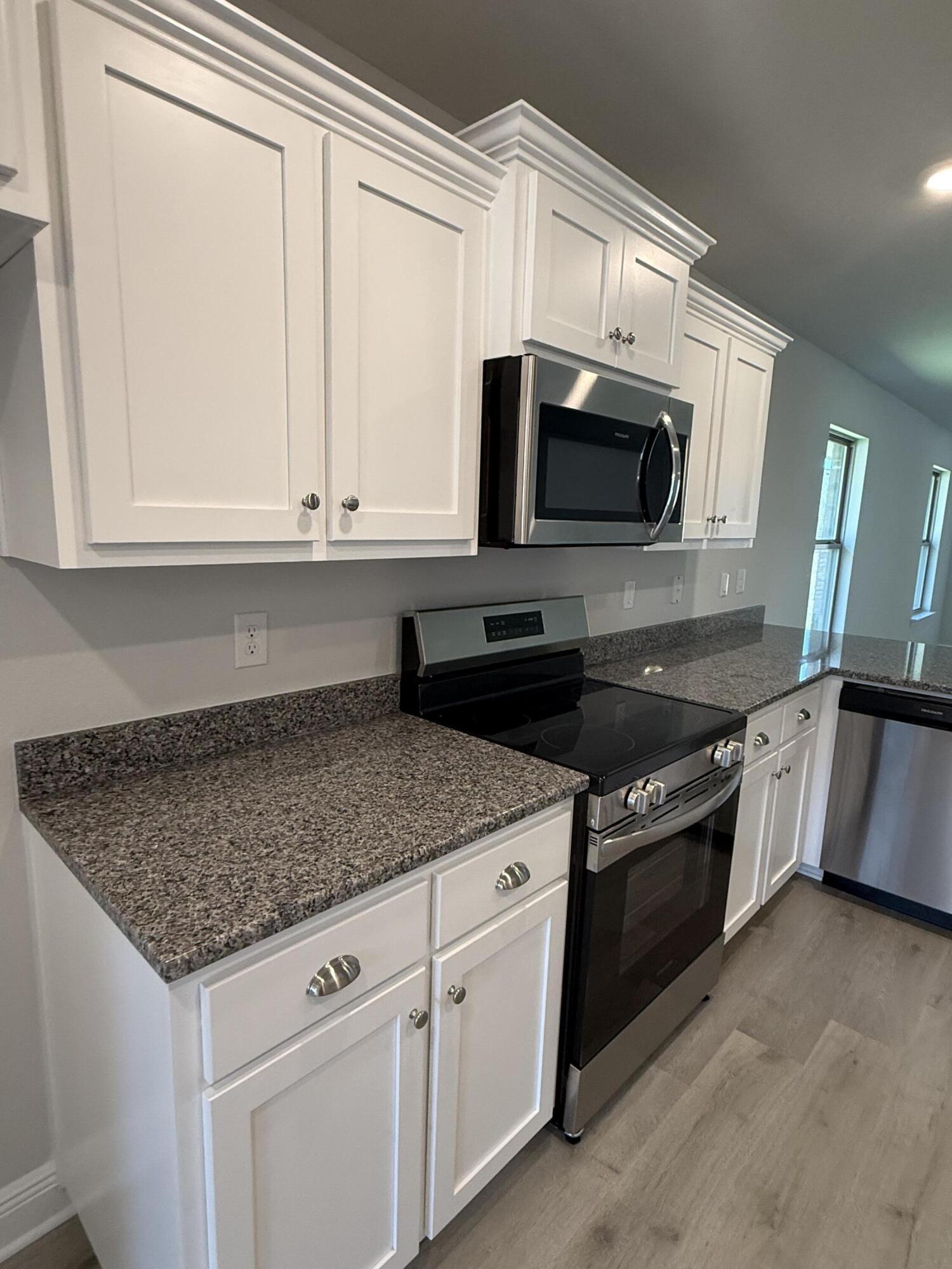 183 Ridgeway Circle Crestview, FL 32536 - Photo 13 of 28 a kitchen with stainless steel appliances granite countertop a sink and a microwave