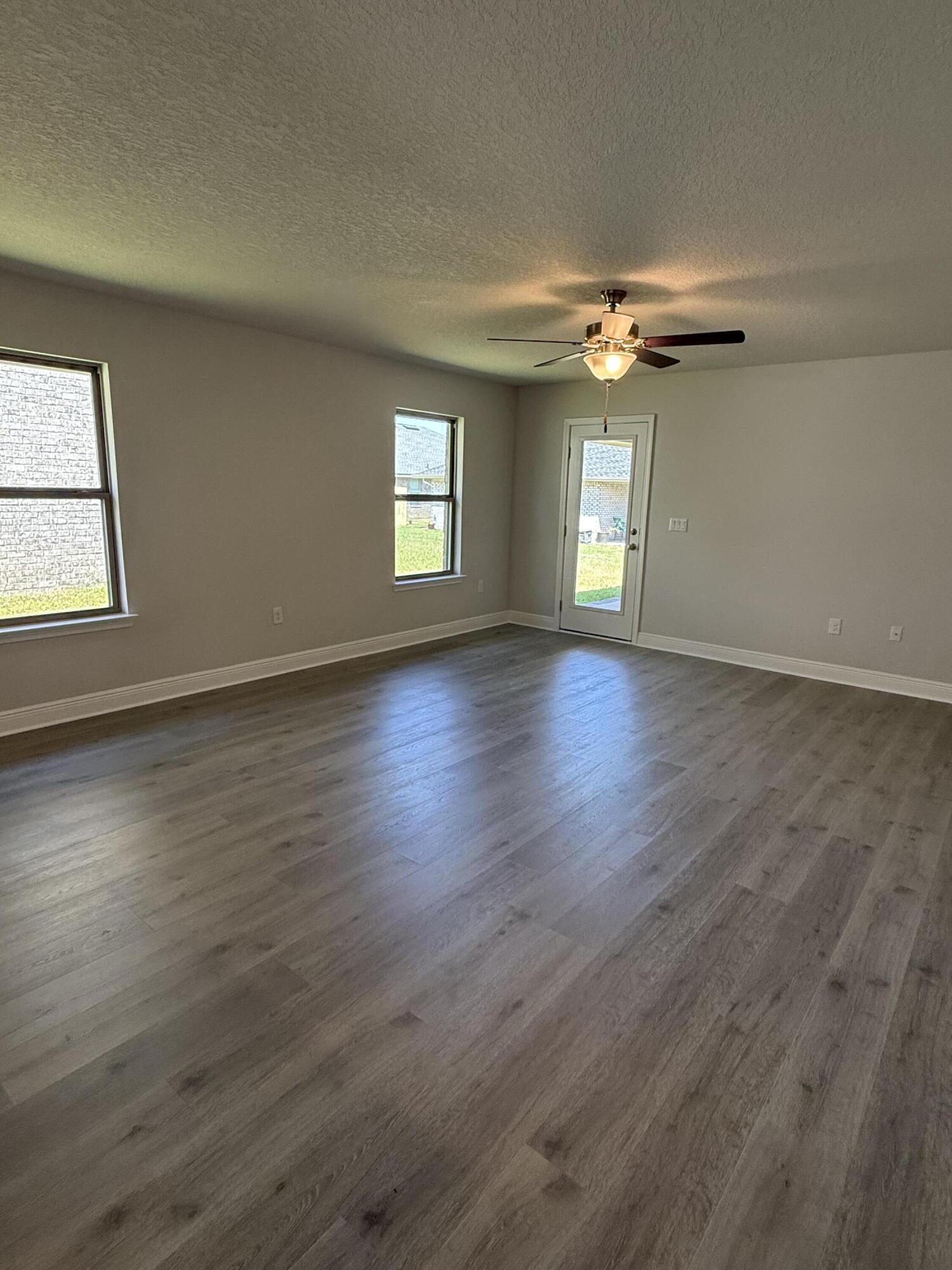 183 Ridgeway Circle Crestview, FL 32536 - Photo 14 of 28 a view of empty room with wooden floor and fan