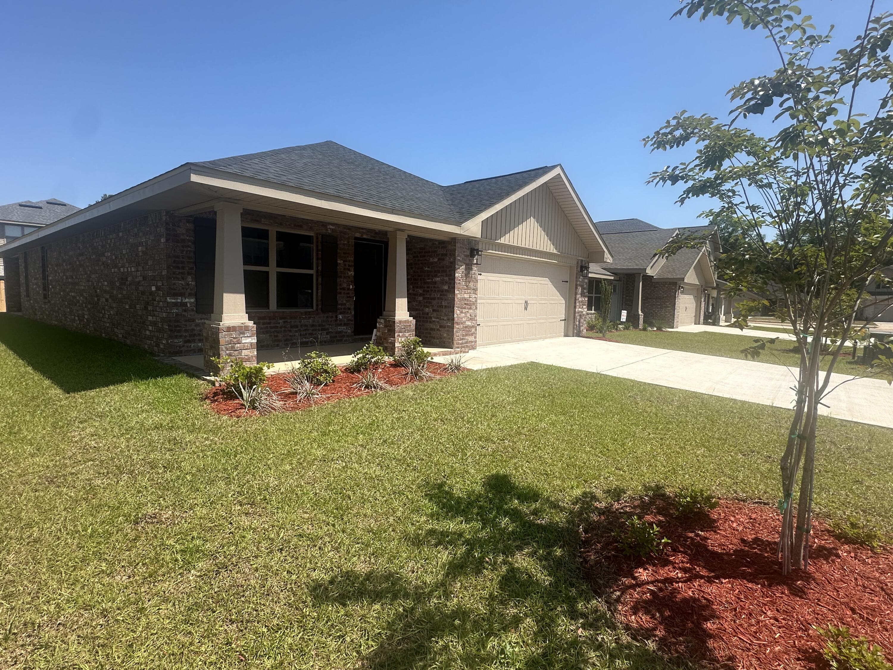 183 Ridgeway Circle Crestview, FL 32536 - Photo 2 of 28 a front view of a house with garden