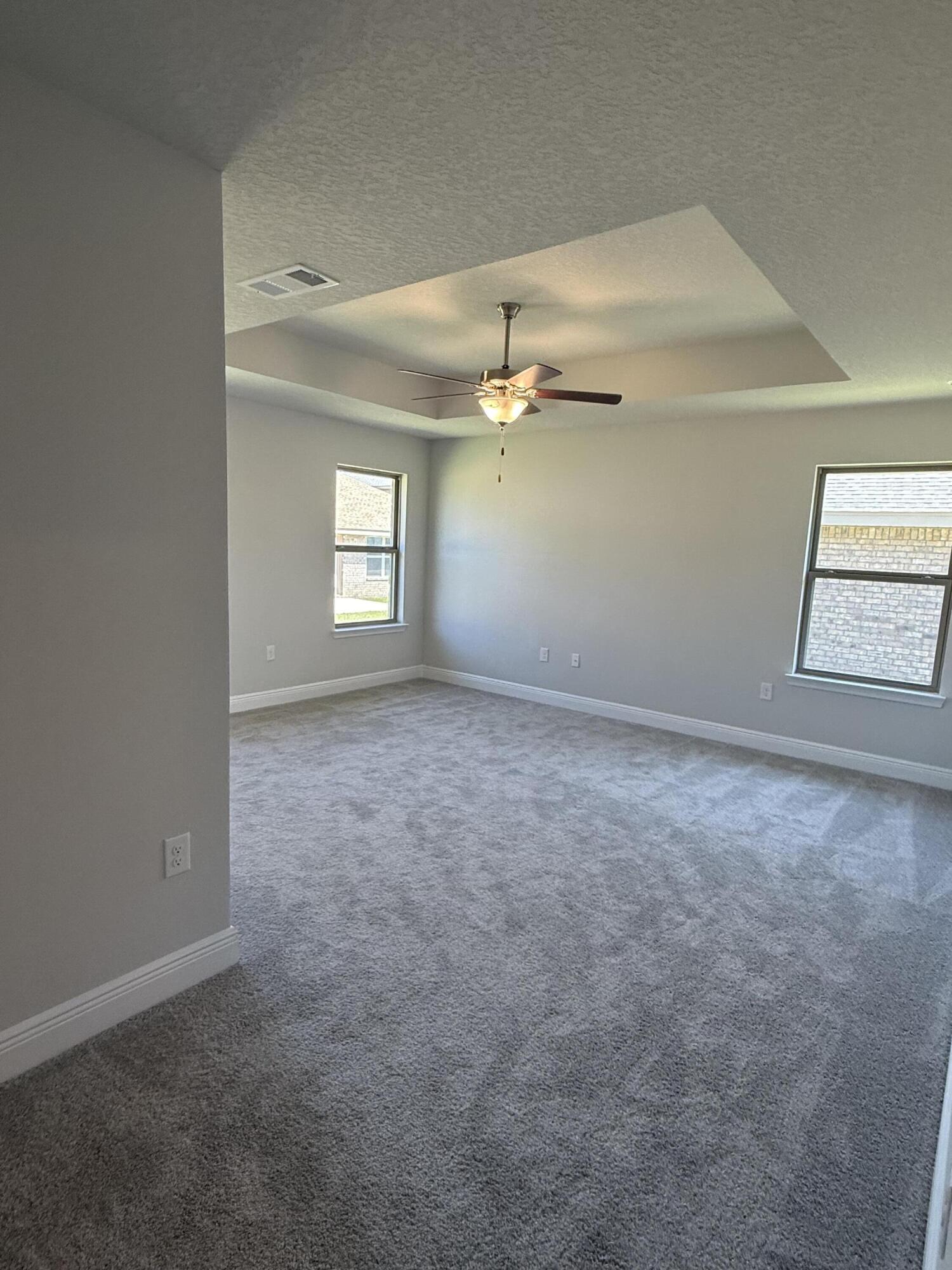 183 Ridgeway Circle Crestview, FL 32536 - Photo 21 of 28 en empty room with windows and ceiling fan