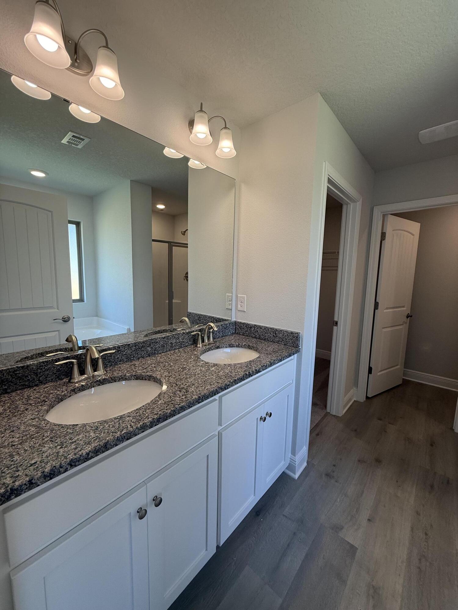 183 Ridgeway Circle Crestview, FL 32536 - Photo 23 of 28 a bathroom with a granite countertop double vanity sink and a mirror