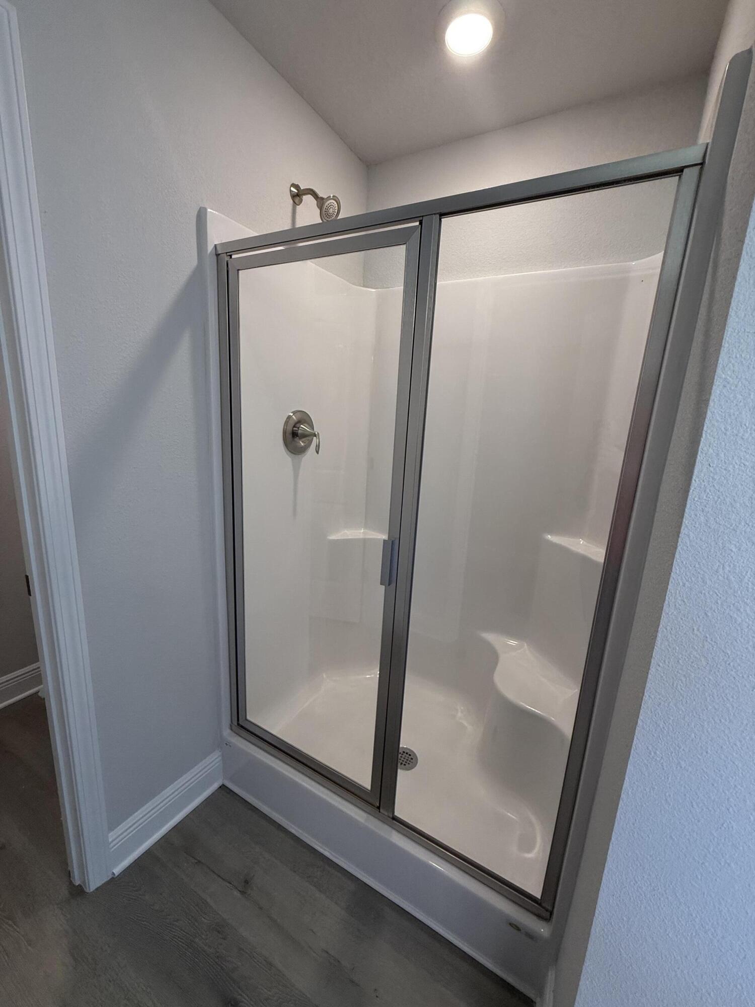 183 Ridgeway Circle Crestview, FL 32536 - Photo 25 of 28 a bathroom with a glass shower door