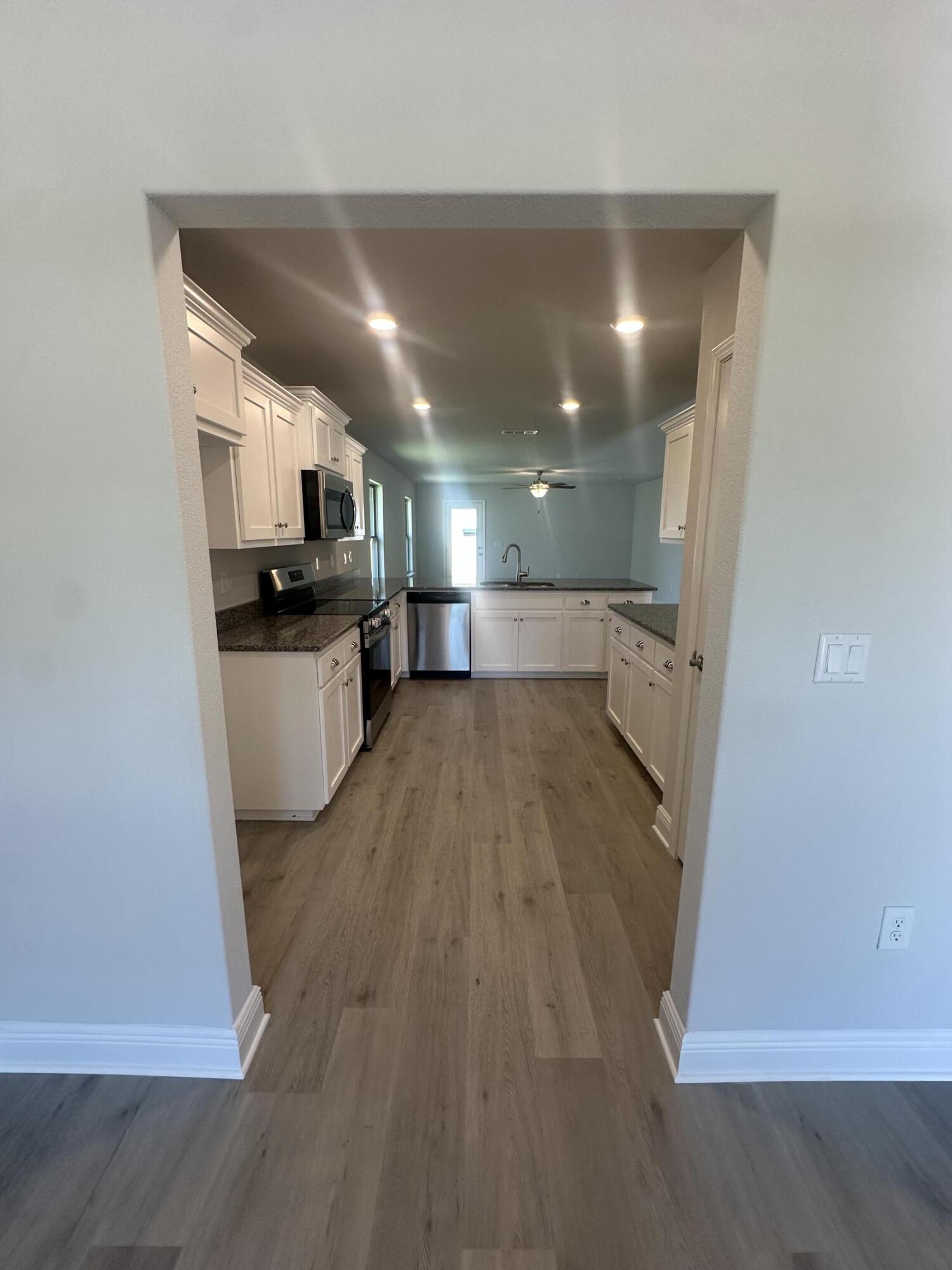 183 Ridgeway Circle Crestview, FL 32536 - Photo 6 of 28 a view of a kitchen with a sink and a refrigerator