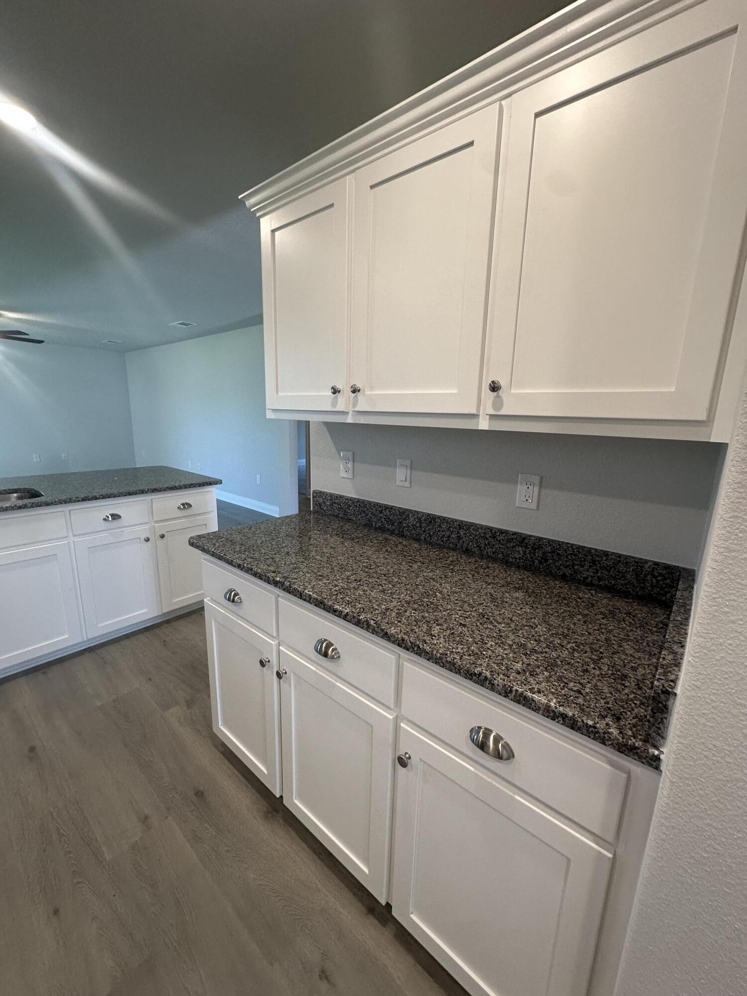183 Ridgeway Circle Crestview, FL 32536 - Photo 8 of 28 a kitchen with granite countertop white cabinets and a sink