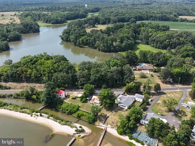 an aerial view of a houses with outdoor space and lake view