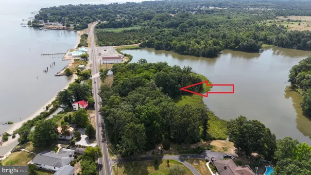 an aerial view of lake and residential houses with outdoor space