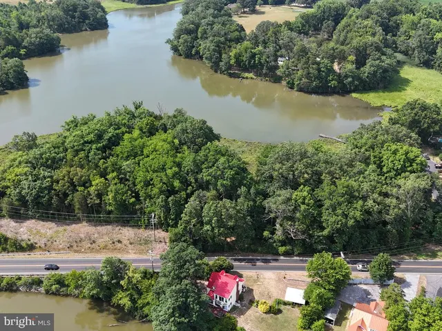 an aerial view of residential house with outdoor space and lake view