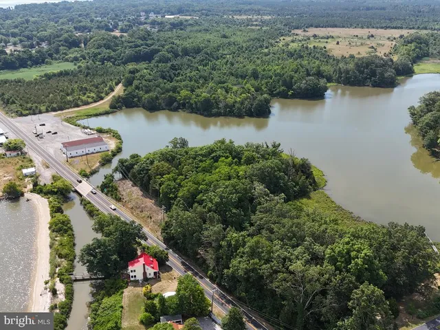 an aerial view of lake and residential houses with outdoor space