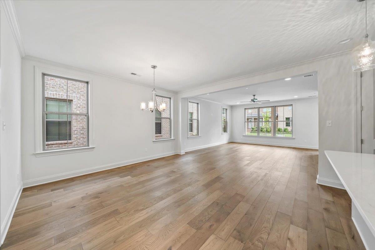 499 Armel Drive Collierville, TN 38017 - Photo 11 of 40 an empty room with wooden floor and windows