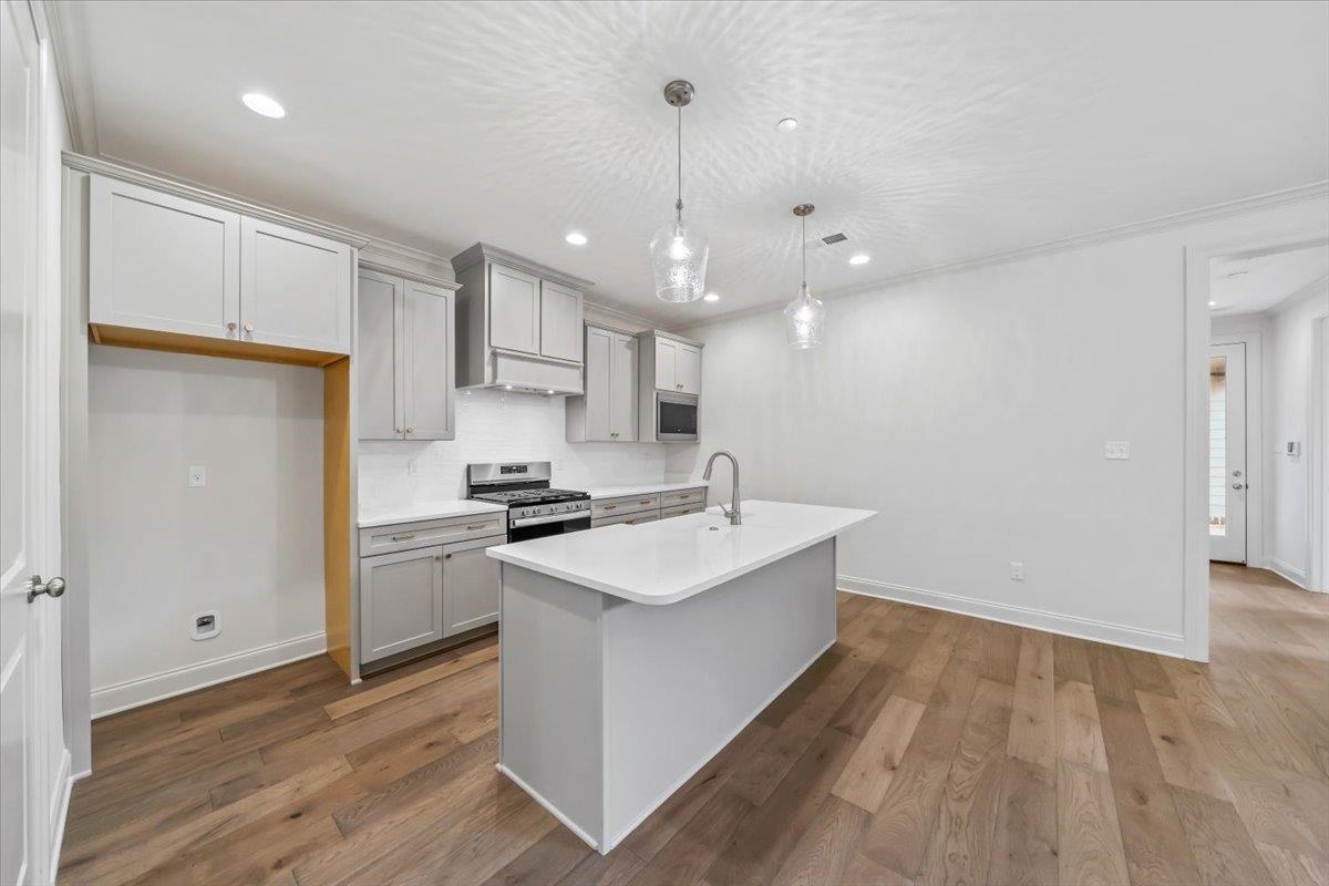 499 Armel Drive Collierville, TN 38017 - Photo 13 of 40 a kitchen with stainless steel appliances granite countertop a sink stove and refrigerator