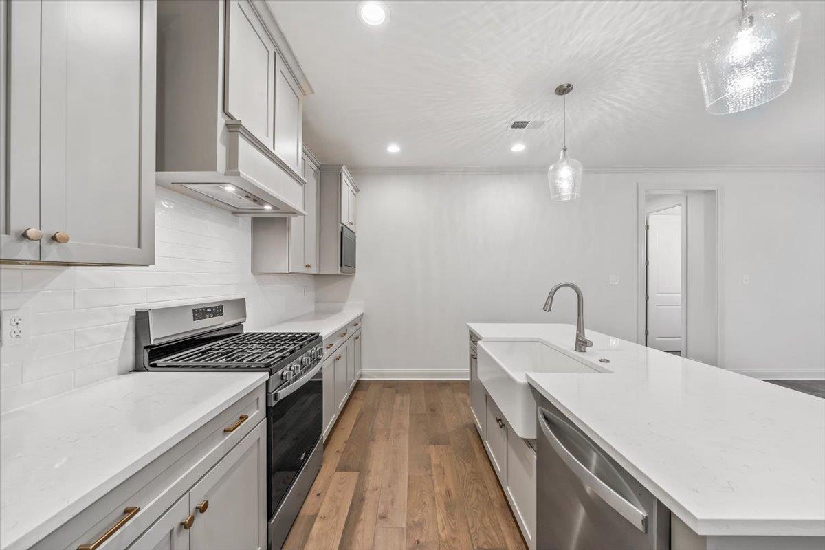 499 Armel Drive Collierville, TN 38017 - Photo 14 of 40 a kitchen with a sink a stove and cabinets