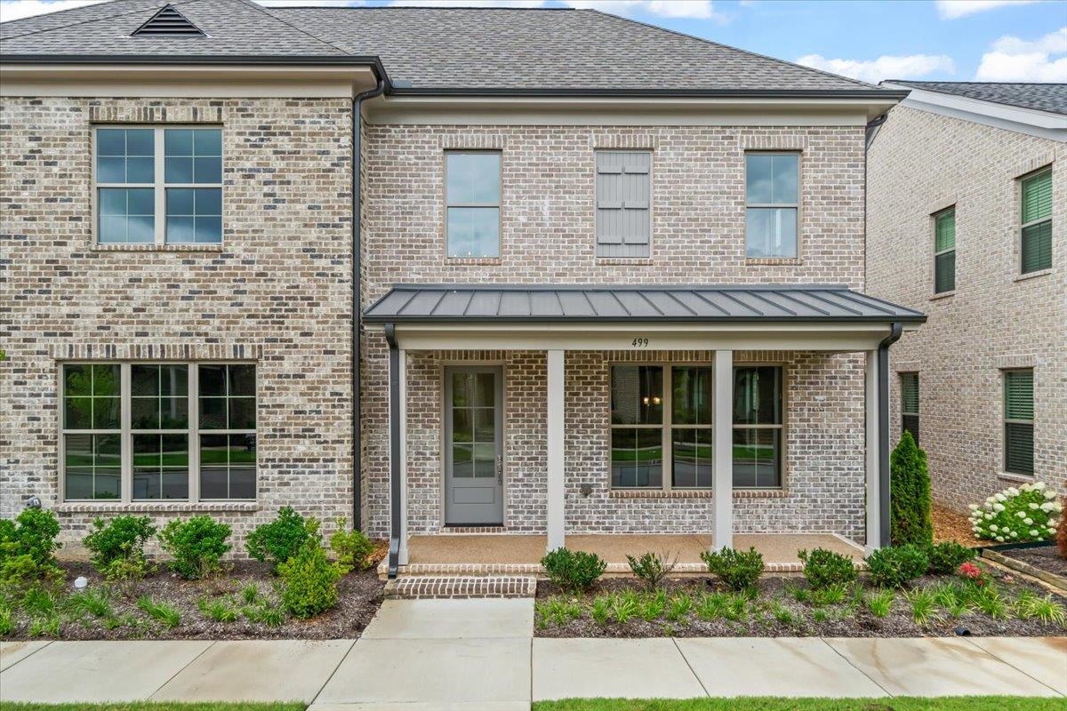 499 Armel Drive Collierville, TN 38017 - Photo 2 of 40 front view of a brick house with a large window and potted plants