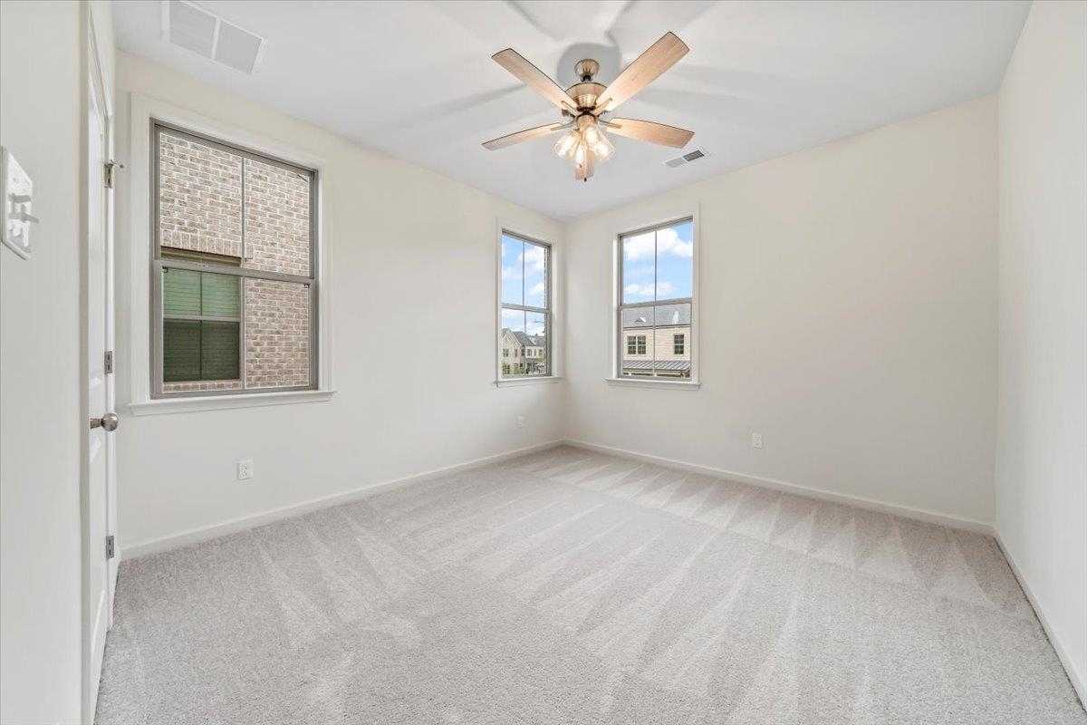 499 Armel Drive Collierville, TN 38017 - Photo 23 of 40 an empty room with windows and chandelier fan
