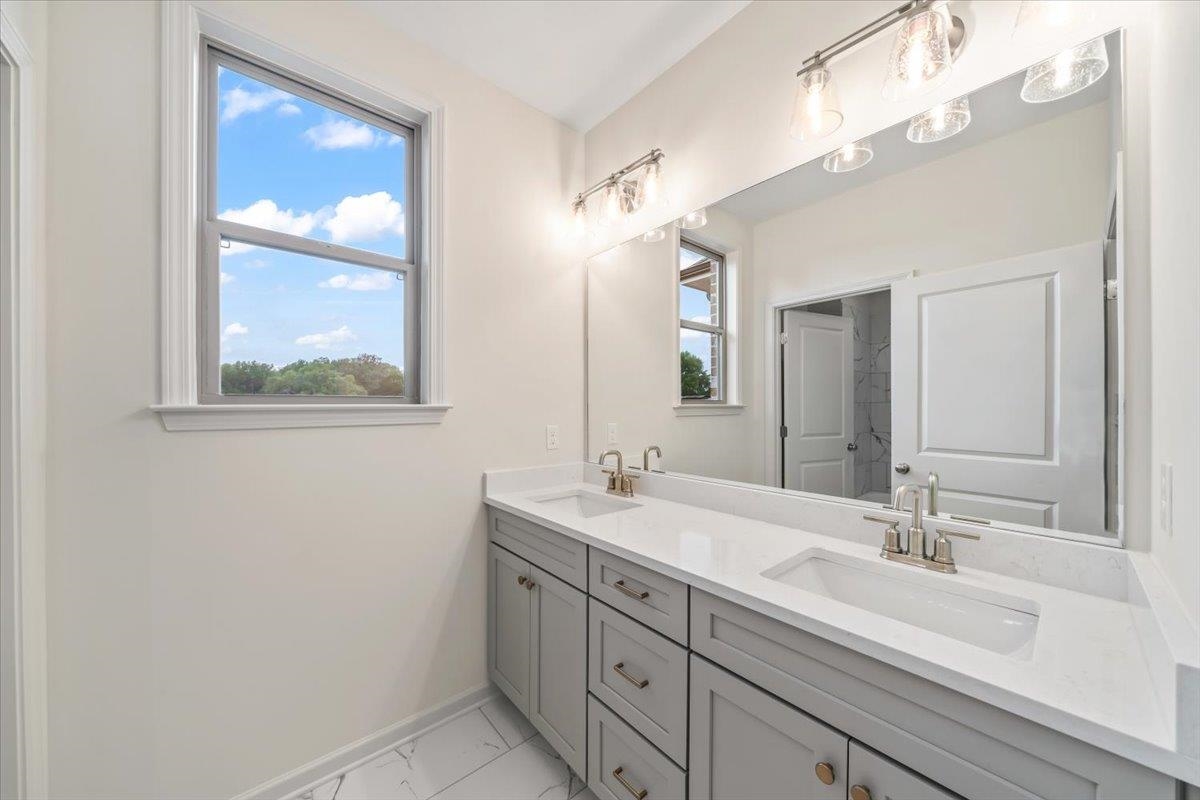 499 Armel Drive Collierville, TN 38017 - Photo 25 of 40 a bathroom with a double vanity sink and a mirror