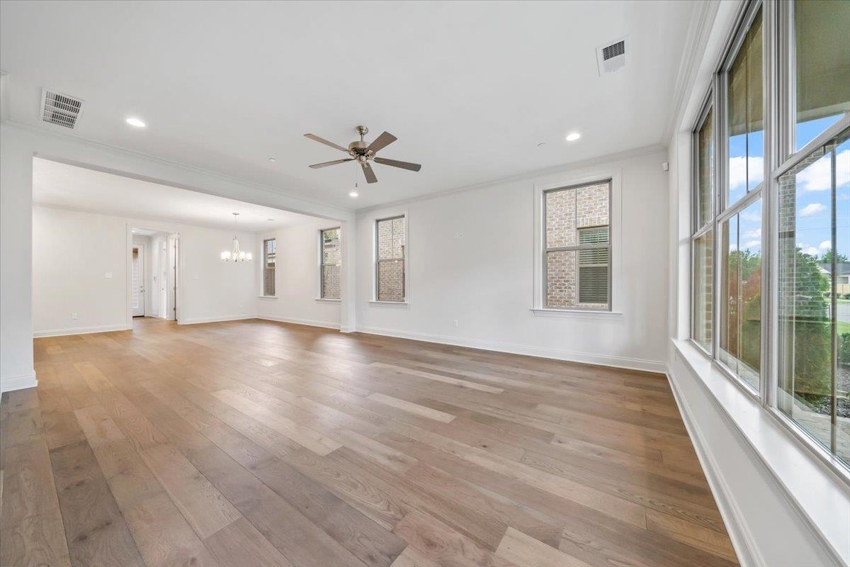 499 Armel Drive Collierville, TN 38017 - Photo 4 of 40 a view of an empty room with a window and wooden floor