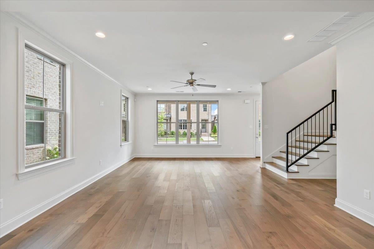 499 Armel Drive Collierville, TN 38017 - Photo 6 of 40 a view of an empty room with wooden floor and a window