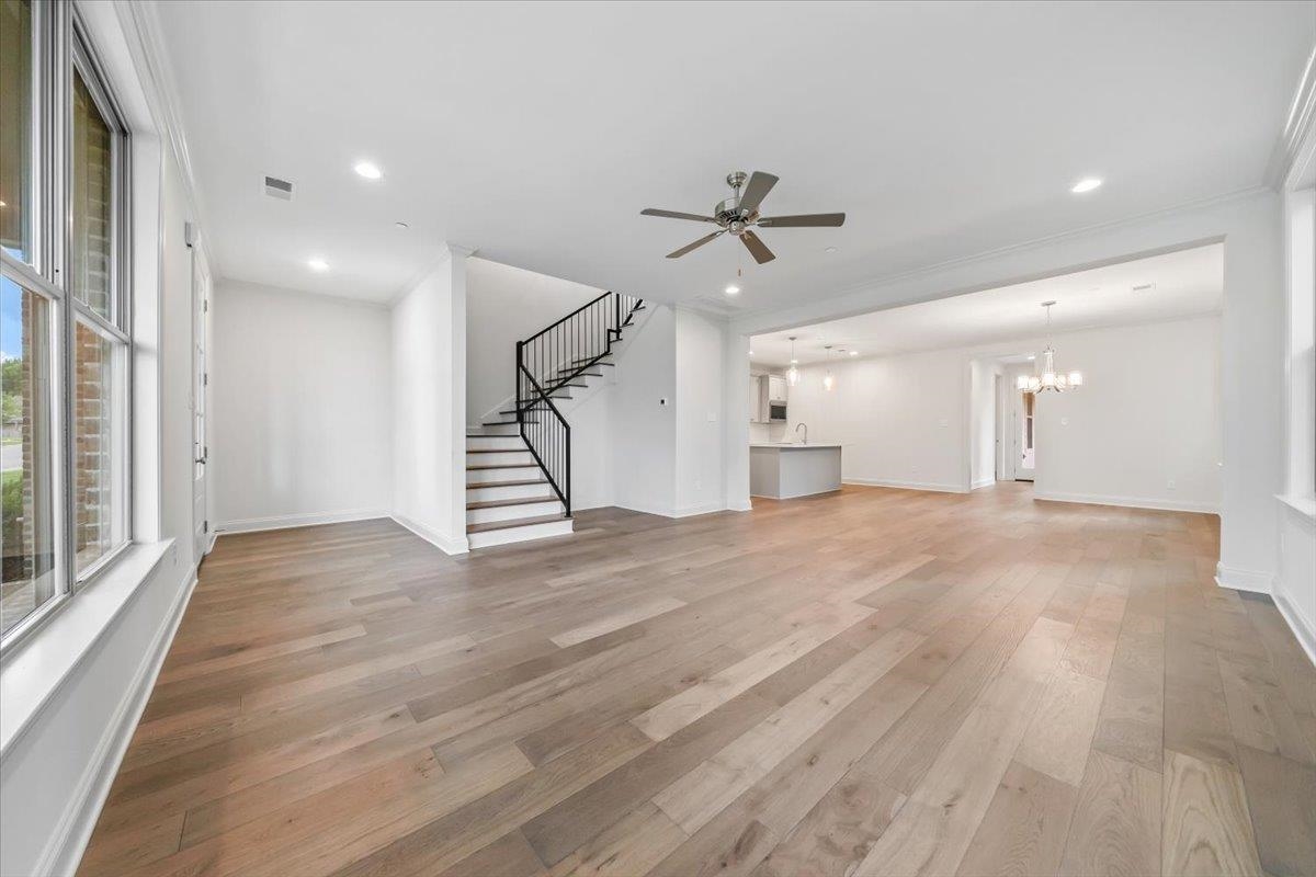 499 Armel Drive Collierville, TN 38017 - Photo 7 of 40 a view of empty room with wooden floor and ceiling fan