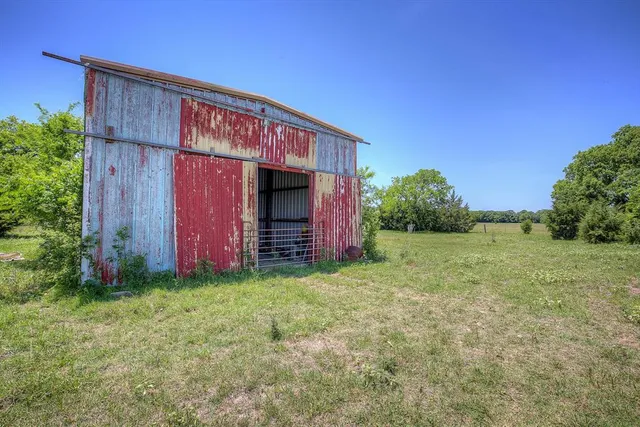 a view of backyard with potted plants and wooden fence
