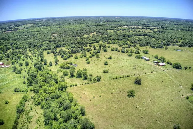 a view of a field with an ocean view
