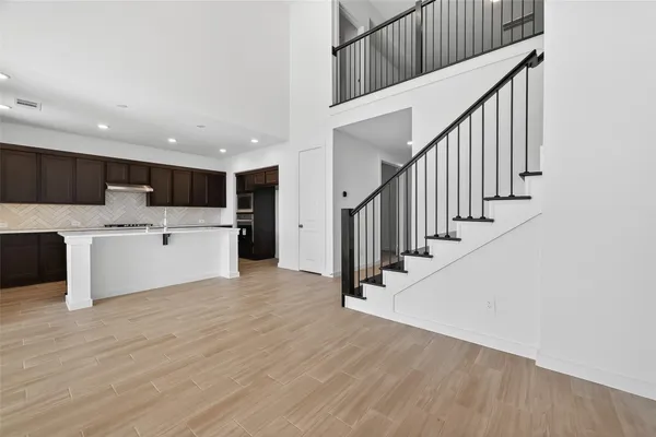 a view of a kitchen with wooden floor and electronic appliances