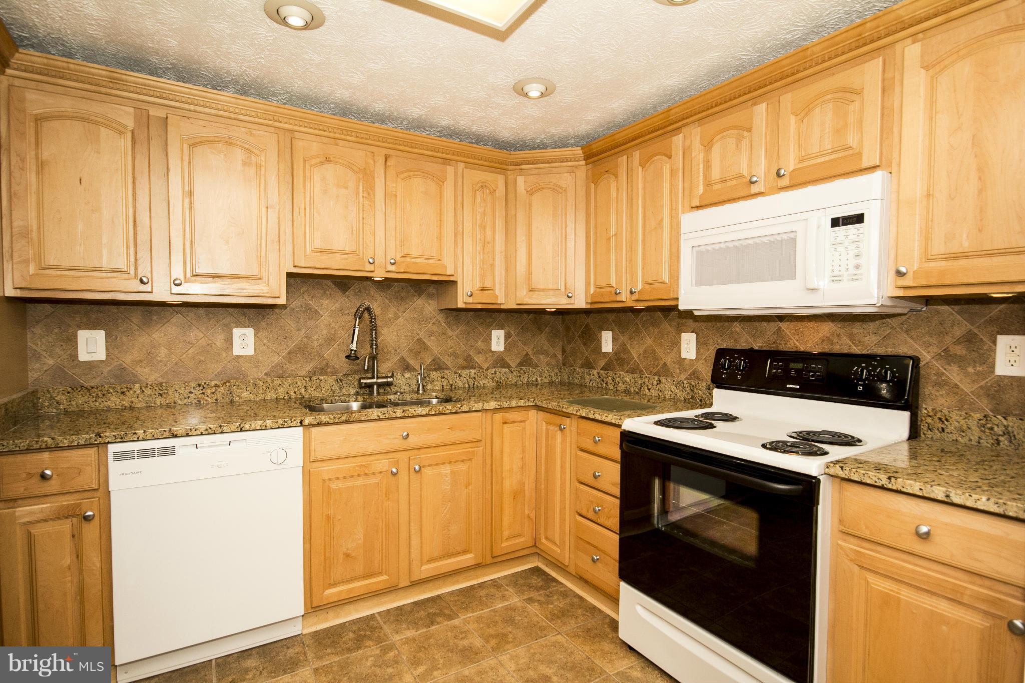 710 Highvilla Road Baltimore, MD 21221 - Photo 14 of 30 a kitchen with granite countertop cabinets stainless steel appliances and a sink