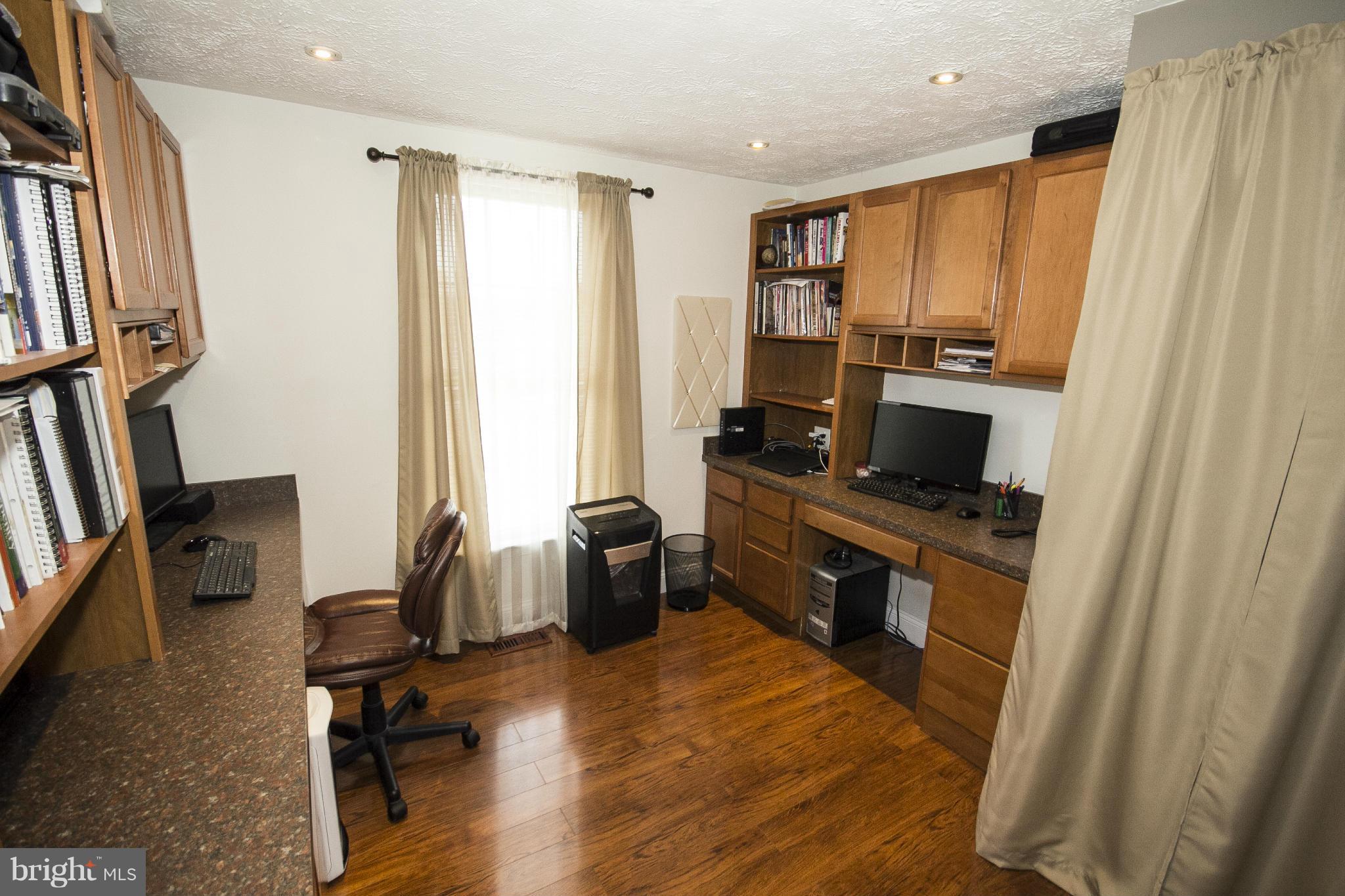 710 Highvilla Road Baltimore, MD 21221 - Photo 22 of 30 a open kitchen with stainless steel appliances a refrigerator a stove a sink dishwasher and wooden cabinets with wooden floor