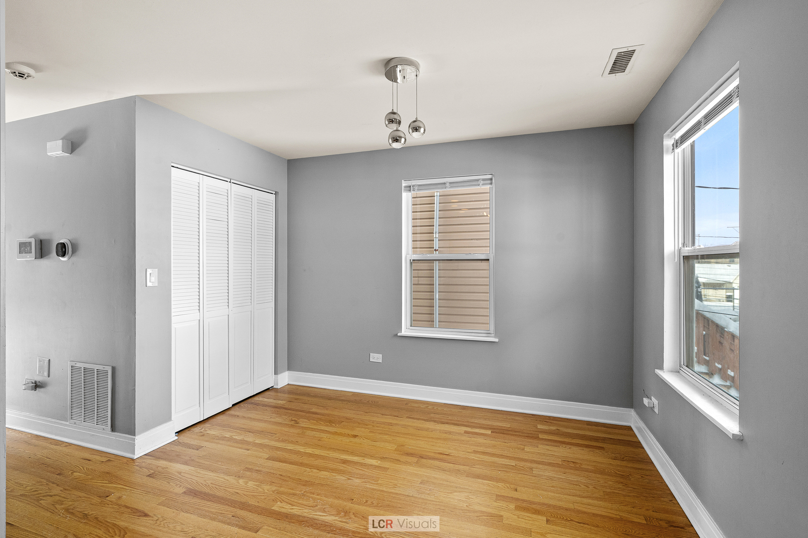3422 West 13th Place, Unit 2 Chicago, IL 60623 - Photo 6 of 13 a view of an empty room with wooden floor and a window