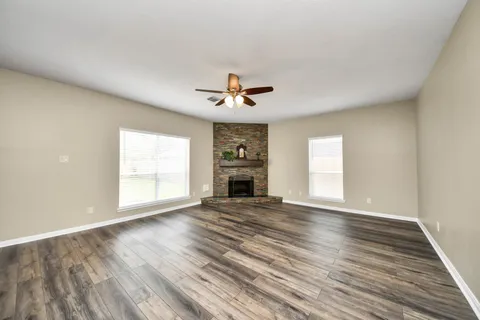 wooden floor that has a fireplace in it