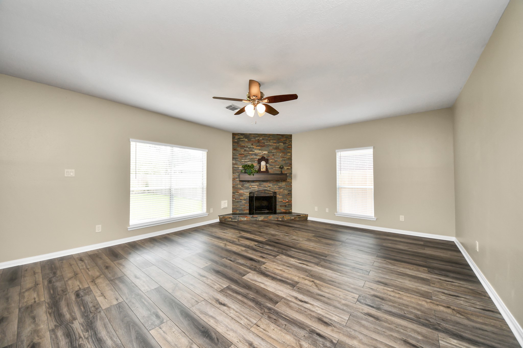7622 McCormick Mill Court Houston, TX 77095 - Photo 7 of 37 wooden floor that has a fireplace in it