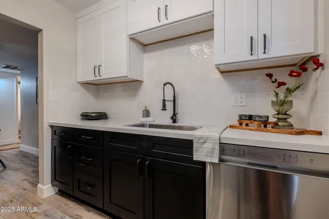 a kitchen with stainless steel appliances a sink a stove and cabinets
