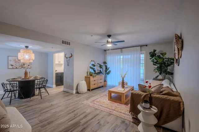 a living room with furniture and a chandelier