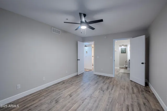 a view of an empty room and wooden floor