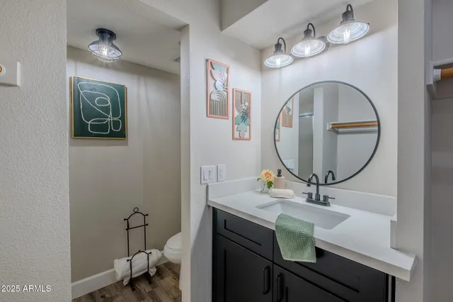 a bathroom with a sink a mirror and a toilet