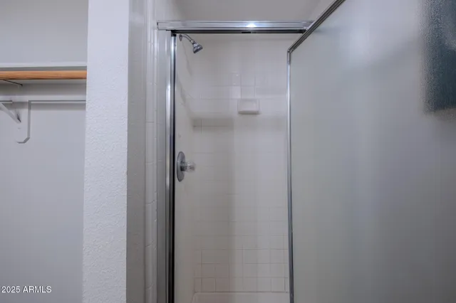 a bathroom with a glass shower door
