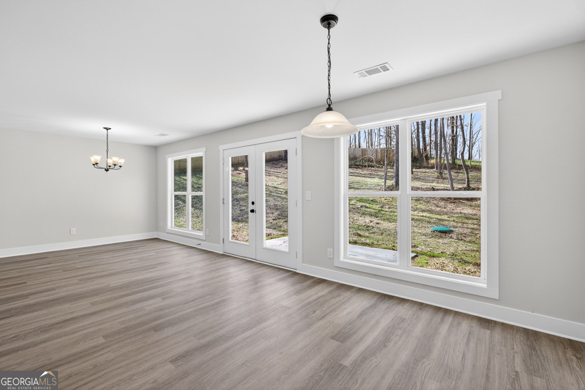 110 Chad Walk, Unit 56 Statham, GA 30666 - Photo 17 of 53 a view of an empty room with wooden floor and a window