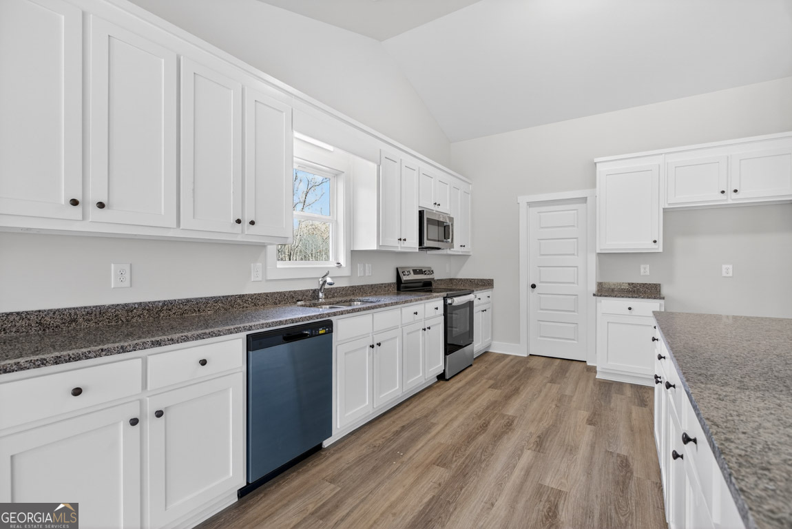 110 Chad Walk, Unit 56 Statham, GA 30666 - Photo 19 of 53 a kitchen with granite countertop white cabinets and white appliances