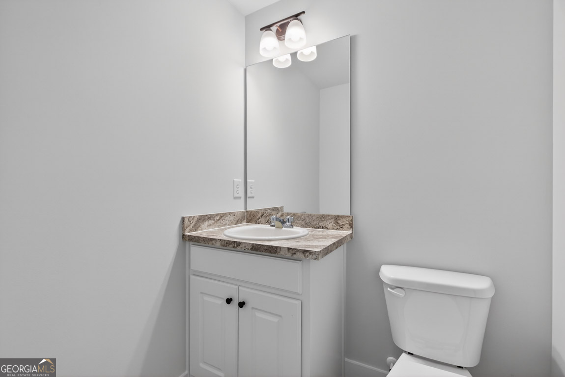 110 Chad Walk, Unit 56 Statham, GA 30666 - Photo 25 of 53 a bathroom with a granite countertop sink and a mirror