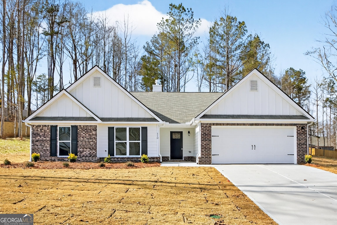 110 Chad Walk, Unit 56 Statham, GA 30666 - Photo 3 of 53 a view of a white house with large windows and wooden fence