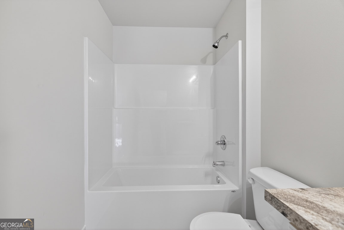 110 Chad Walk, Unit 56 Statham, GA 30666 - Photo 37 of 53 a bathroom with a granite countertop bathtub shower sink vanity and toilet