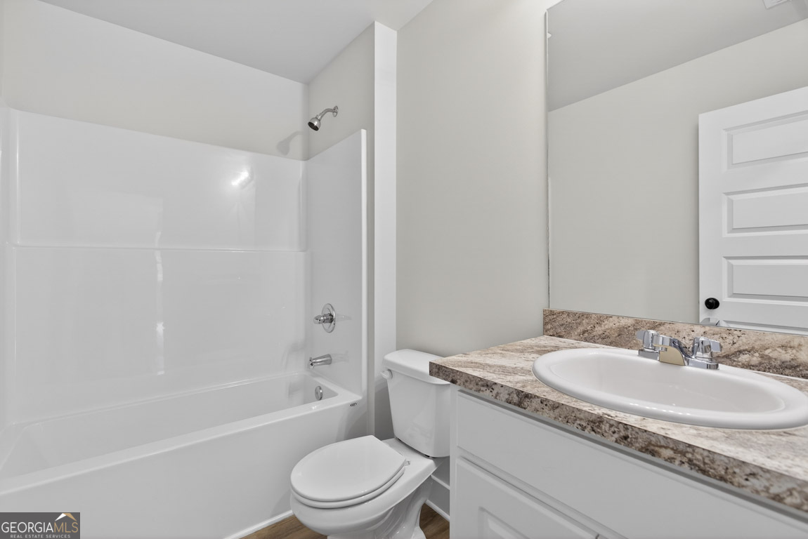 110 Chad Walk, Unit 56 Statham, GA 30666 - Photo 38 of 53 a bathroom with a granite countertop sink a toilet and shower