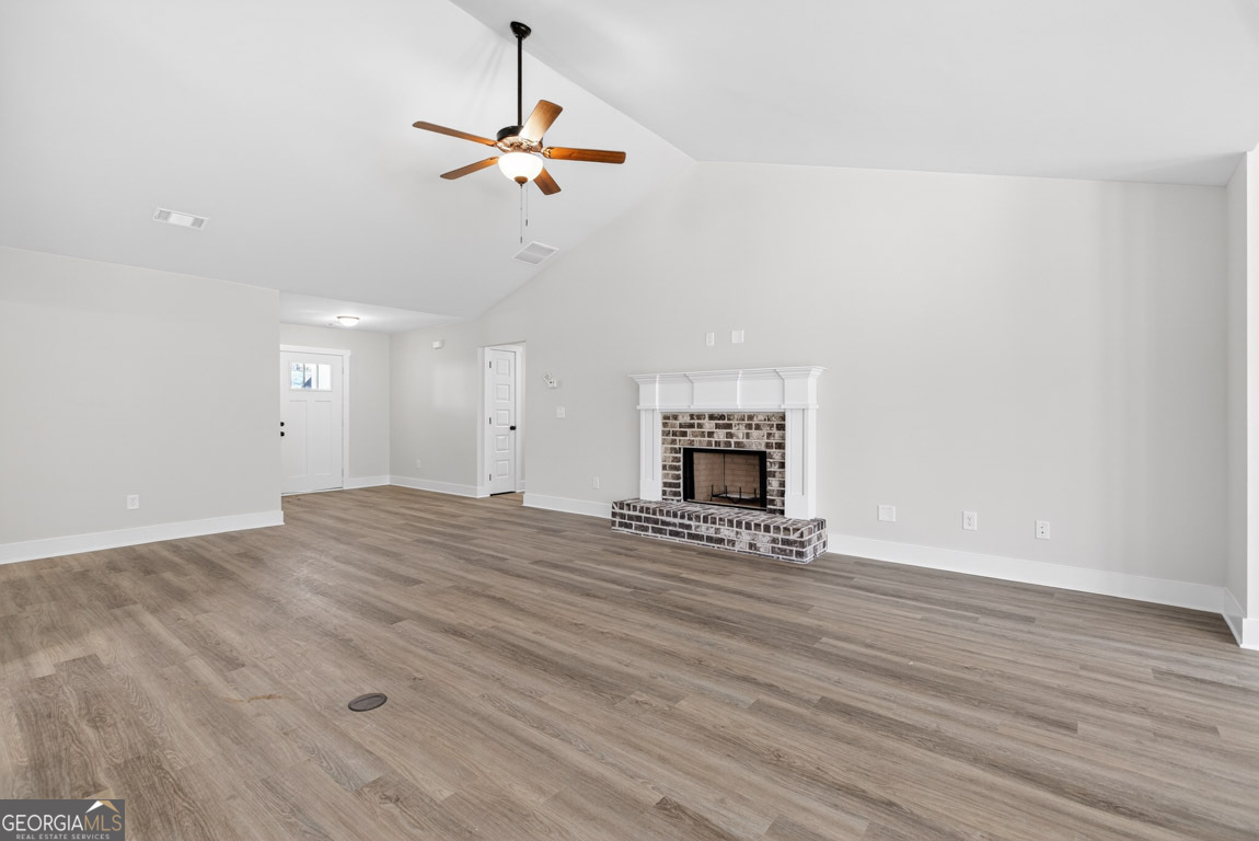 110 Chad Walk, Unit 56 Statham, GA 30666 - Photo 10 of 53 a view of empty room with wooden floor and fireplace