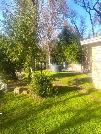 a view of a yard with swimming pool