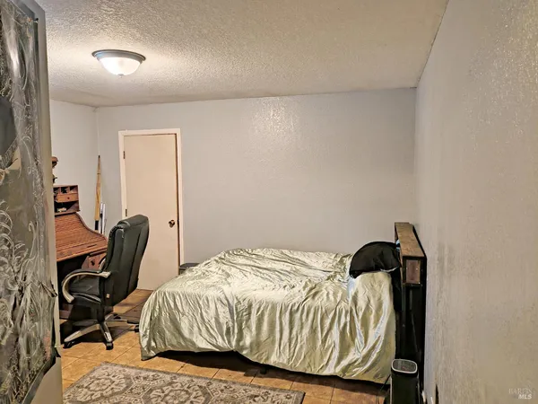 a bedroom with a bed a desk and chair