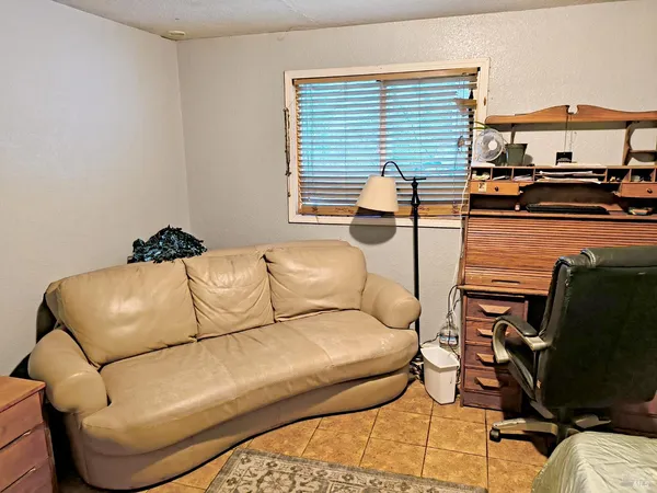 a living room with furniture and a lamp