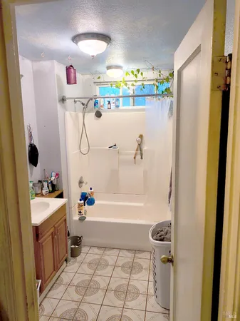 a bathroom with a tub a sink and a shower