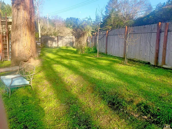 a view of yard with swimming pool and trees