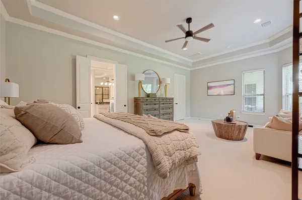 a bedroom with a bed and ceiling fan