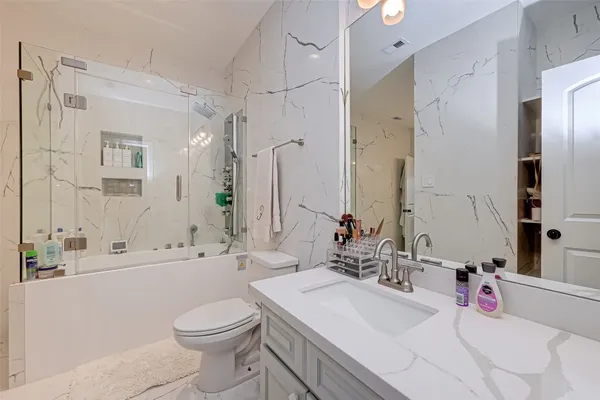 a spacious bathroom with a bathtub shower sink and mirror